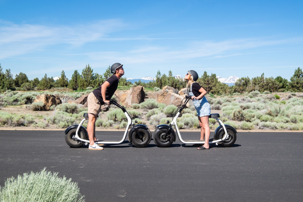 Couple enjoying scooters at Pronghorn Resort in Bend OR