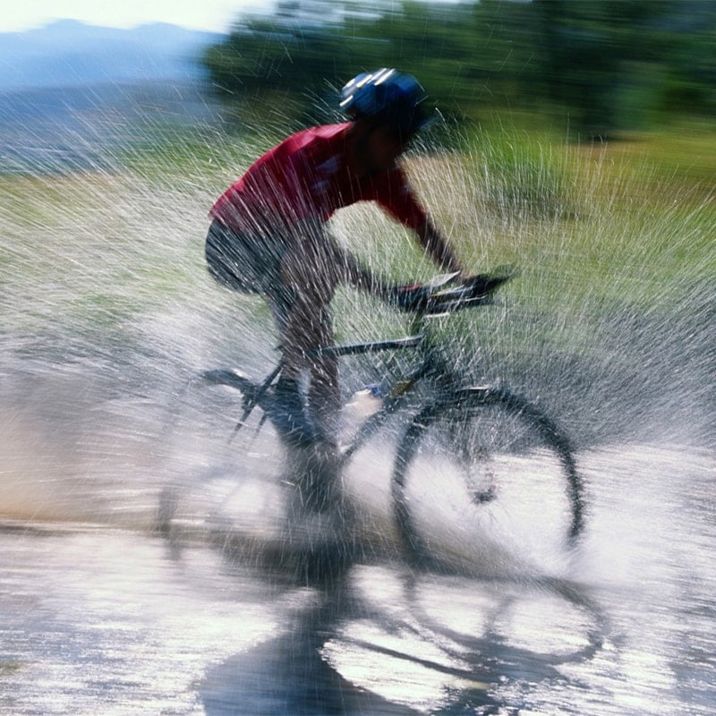 Bicycle bicyclist splashing through water | Pronghorn Bend Oregon